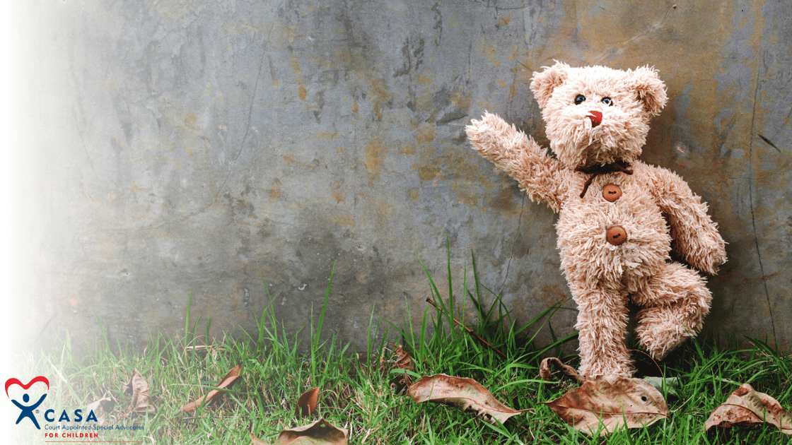 bear standing against a concrete wall