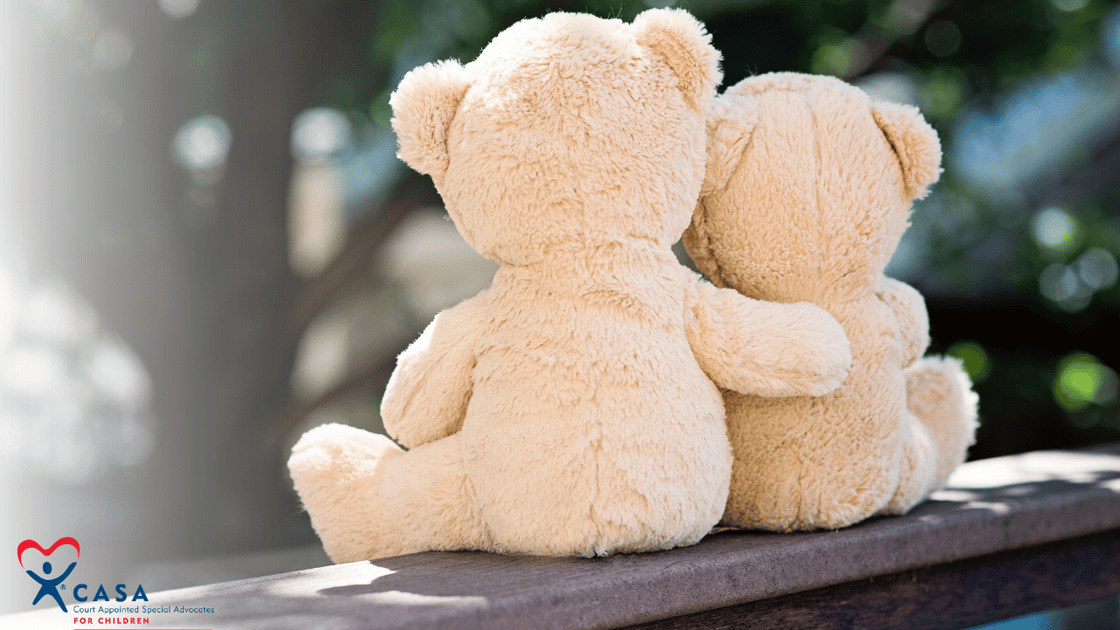 two teddy bears hugging